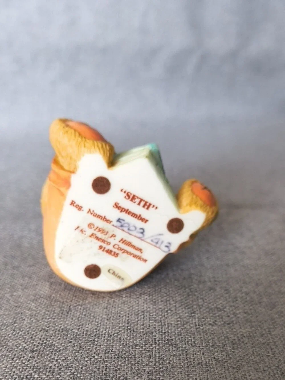Cherished Teddies tan bear figurine with pastel blue and pink accents